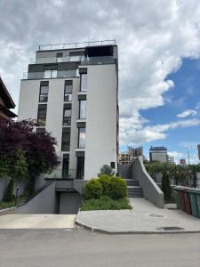 a tall white building with stairs in front of it at Aviatiei-Boutique in Bucharest