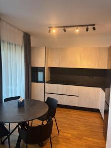 a kitchen and dining room with a table and chairs at Aviatiei-Boutique in Bucharest