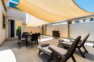 a patio with a table and chairs on a balcony at SUNNY SWEET HOME OLGA in Torrevieja