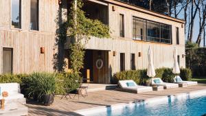a house with a swimming pool next to a building at Casa Flor in Punta del Este