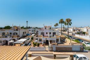 arial view of a city with buildings and palm trees at SUNNY SWEET HOME OLGA in Torrevieja
