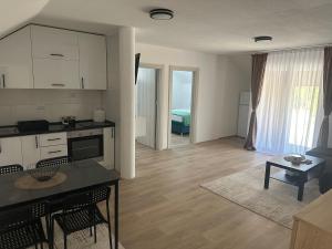a kitchen and living room with a table and chairs at Daily corner in Bujanovac