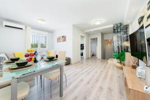 a living room and dining room with a table and chairs at SUNNY SWEET HOME OLGA in Torrevieja