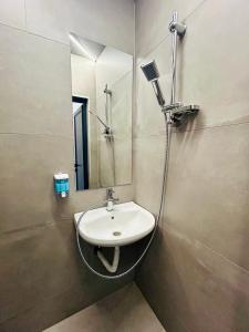 a bathroom with a sink and a mirror at Joy Station Appartment 2 in Sofia