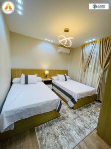 a hotel room with two beds and a window at Stylish & Trendy in Cairo +9 photos