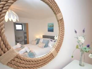 a bedroom with a bed and a mirror at 3 Bed in Westward Ho 40820 in Northam