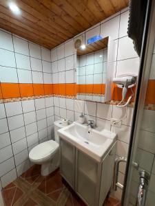 a bathroom with a sink and a toilet and a mirror at El Pequeño Refugio - C in Chío +10 photos