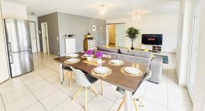 a kitchen and living room with a table and a couch at Chic 2BR easy access to the train station-2b in Luxembourg