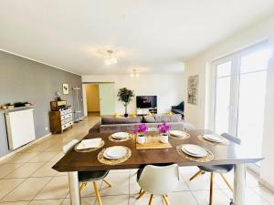 a living room with a table and a couch at Chic 2BR easy access to the train station-2b in Luxembourg