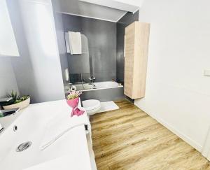 a bathroom with a tub and a toilet and a sink at Chic 2BR easy access to the train station-2b in Luxembourg