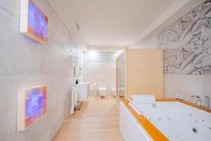 a bathroom with a bath tub and a sink at Halanus Agriexperience in Alanno +92 photos