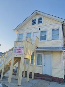 a house with a large wooden staircase in front of it at Shore Beach Houses - 38 A Lincoln Avenue in Seaside Heights +4 photos