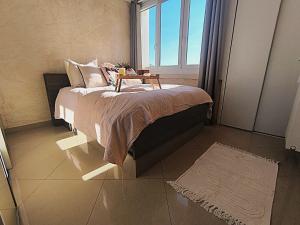 a bedroom with a bed with a table on it at LeRelaisdOdile-Idéal Pro & Famille-Proche Métro-Fort de Mons in Mons-en-Baroeul