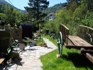 a bench sitting in the grass next to a path at Adeko Hotel in Barakaldo