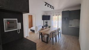 a kitchen and dining room with a table and chairs at MarMeg Guesthouse in Tirana