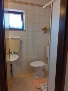 a bathroom with a toilet and a sink at Calmaria Studio Apartments in Poreč