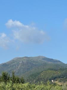 a view of a mountain with clouds in the sky at Casa Sant Anna Golf in Cogoleto