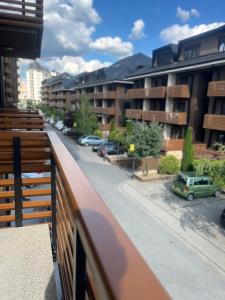 a balcony with a view of a street and buildings at Valor in Zlatibor