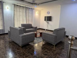 a living room with two chairs and a tv at China appartment in Kiungani