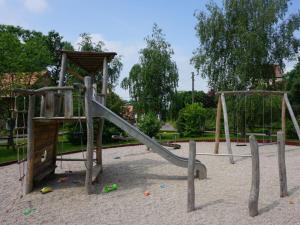 a playground with a slide in a park at Apartment near Leipzig in Taucha