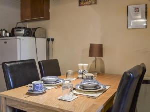 a dining room table with a blue and white dinner set at Ivy Cottage in Elton