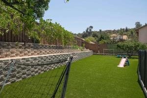 a playground with a pink slide on the grass at Backyard Oasis Private Villa Pool Hot Tub in El Cajon +67 photos