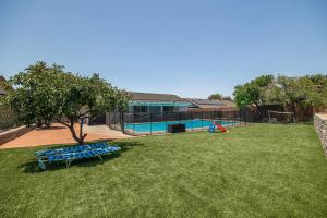 a playground with a blue bench in a yard at Backyard Oasis Private Villa Pool Hot Tub in El Cajon