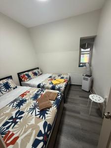 a bedroom with two beds and a window at Queen Street AC SUITE-Free Wifi& Self Checkin in Toronto