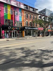 an empty street in a city with shops and buildings at Queen Street AC SUITE-Free Wifi& Self Checkin in Toronto
