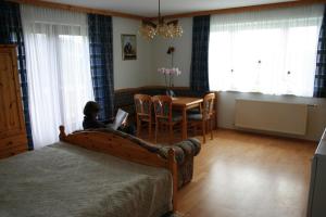 a young child sitting on a bed using a laptop at Graglerhof in Liebenfels