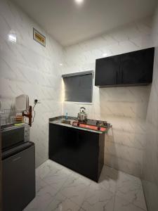 a kitchen with a sink and a counter top at Comfortable Studio apartment in ogudu by Magnanimous apartments in Lagos +6 photos