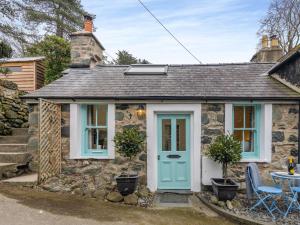 un cottage in pietra con porta blu di 2 Bed in Llwyngwril 58564 a Llwyngwril