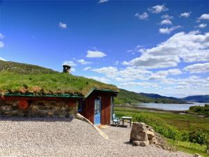 a building with a grass roof with a bench outside at 1 Bed in Acharacle CA368 in Kilchoan +14 photos