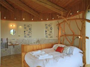 a bedroom with a large bed with a wooden frame at 1 Bed in Acharacle CA368 in Kilchoan