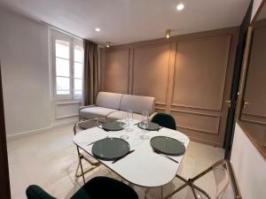 a dining room with a white table and chairs at Nomad in Cassis