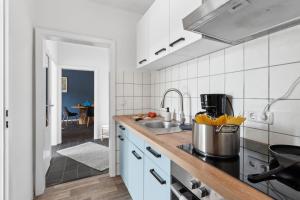 a kitchen with a sink and a counter top at Business Apartment Alte Post in Unterlüß