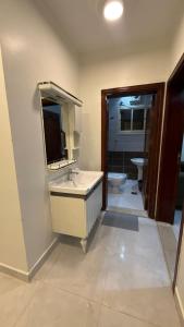 a bathroom with a sink and a mirror and a toilet at شقق الريم in Medina +33 photos