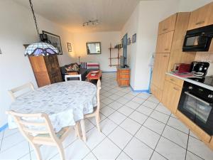 a kitchen with a table and a dining room at Atlantik in Loperhet