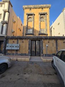 a building with two windows and a car parked in front at شقق الريم in Medina