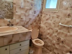a bathroom with a toilet and a sink at Maison en campagne avec chambre mezzanine in Priziac +3 photos
