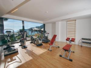 a gym with exercise equipment and a large window at Hotel Continental in Santa Margherita Ligure