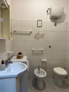 a bathroom with a toilet and a sink at Residenza Anagnina in Rome +8 photos