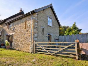 an old stone house with a wooden gate at 1 Bed in Charmouth CIBAR in Whitchurch Canonicorum