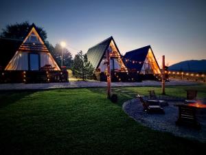 a group of tents with lights on the grass at Krushevski Konaci 2 in Kruševo