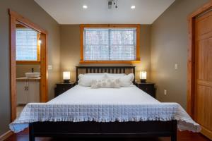 a bedroom with a large white bed with two pillows at Wellness Retreat Zen Oasis DOGS Spa Hot Tub in Cosby +65 photos