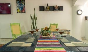 a dining room table with wine glasses on it at Hostal Casa Yare Soul in Rodadero