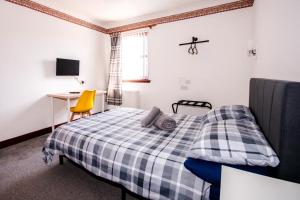 a bedroom with a bed and a desk and a chair at Weston House Keith in Keith +21 photos