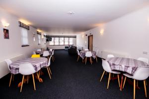 a waiting room with tables and chairs in a building at Weston House Keith in Keith