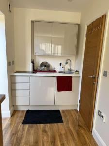 a small kitchen with a sink and a counter at The Paradise Retreat in Crawley +2 photos