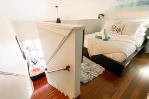 a small bedroom with a bed with a door open at Charming Tremblant 1 Bedroom -Pool Hot Tub in Mont-Tremblant +14 photos